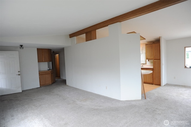 1415 84th St SE Unit 136, Everett, WA 98208 - unfurnished living room with vaulted ceiling with beams and light colored carpet
