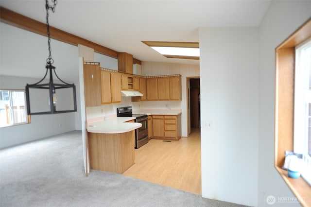 1415 84th St SE Unit 136, Everett, WA 98208 - kitchen featuring light countertops, light colored carpet, under cabinet range hood, stainless steel electric stove, and a peninsula