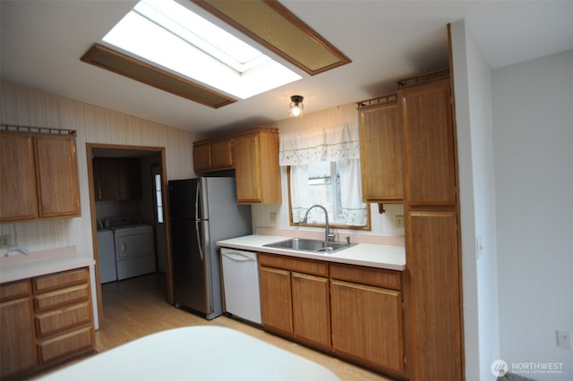 1415 84th St SE Unit 136, Everett, WA 98208 - kitchen with dishwasher, lofted ceiling, a sink, washer and dryer, and freestanding refrigerator