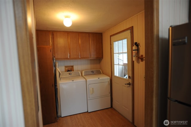 1415 84th St SE Unit 136, Everett, WA 98208 - washroom with light wood finished floors, washer and dryer, and cabinet space