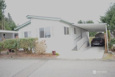 1415 84th St SE Unit 136, Everett, WA 98208 - view of side of home with driveway and a carport