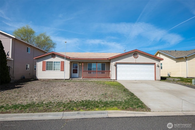 single story home with a garage, driveway, and covered porch