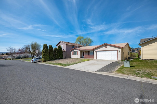 ranch-style house with an attached garage, driveway, and a front lawn