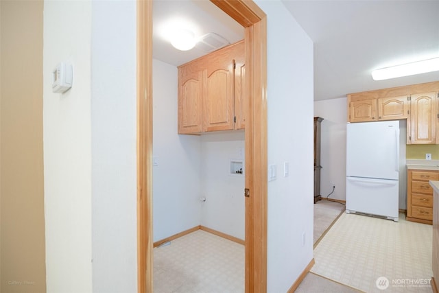 hallway featuring baseboards and light floors