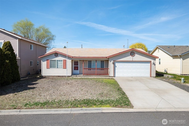 ranch-style home featuring an attached garage, driveway, and a porch