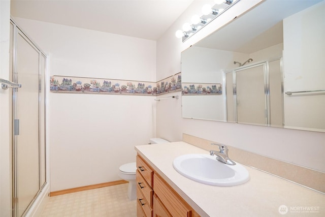 full bathroom with toilet, tile patterned floors, a stall shower, and vanity