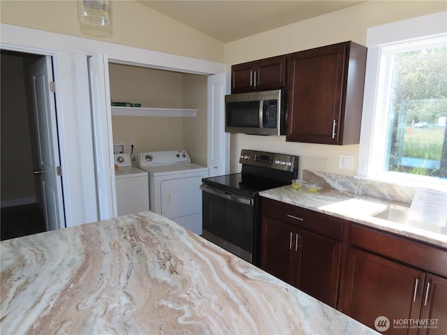 943 Silver King Ave SE, Ocean Shores, WA 98569 - kitchen with stainless steel microwave, electric range, separate washer and dryer, light stone counters, and lofted ceiling