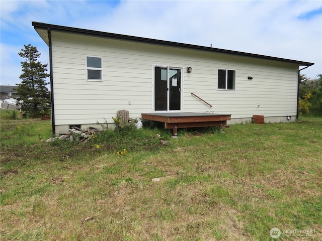 943 Silver King Ave SE, Ocean Shores, WA 98569 - back of house featuring a lawn and a wooden deck