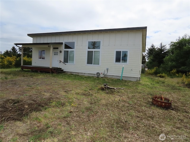 943 Silver King Ave SE, Ocean Shores, WA 98569 - back of property with board and batten siding, an outdoor fire pit, and a porch
