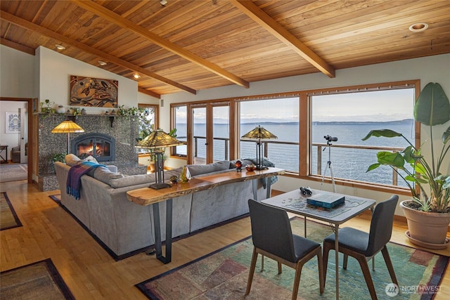 681 Smugglers Cove Rd, Friday Harbor, WA 98250 - living room featuring lofted ceiling with beams, a water view, a tile fireplace, wood finished floors, and wood ceiling