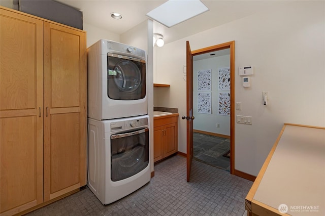 681 Smugglers Cove Rd, Friday Harbor, WA 98250 - washroom featuring cabinet space, baseboards, and stacked washer / drying machine