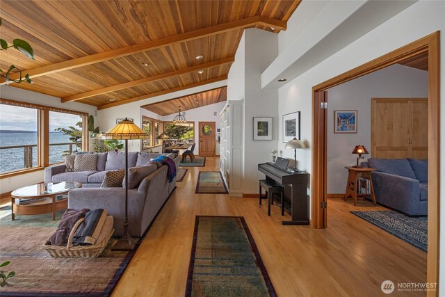 681 Smugglers Cove Rd, Friday Harbor, WA 98250 - living room featuring a water view, light wood finished floors, baseboards, beam ceiling, and wood ceiling