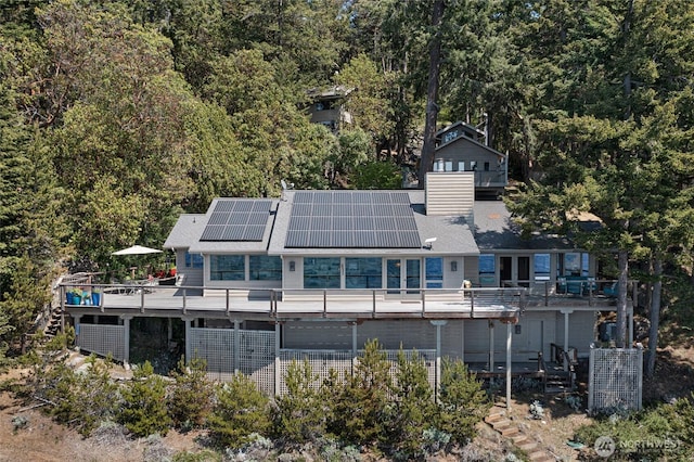 681 Smugglers Cove Rd, Friday Harbor, WA 98250 - exterior space with stairs, solar panels, a wooden deck, and a chimney