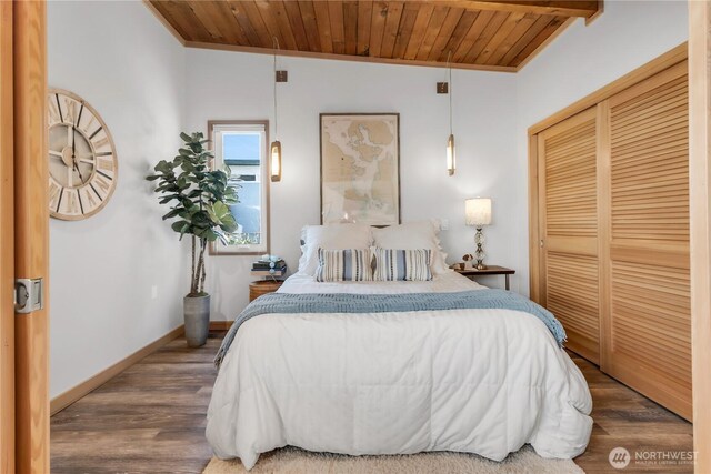 bedroom featuring a closet, ornamental molding, wood finished floors, and wooden ceiling
