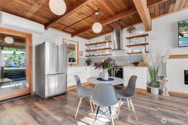 dining space with dark wood-style flooring, a wall unit AC, and wooden ceiling