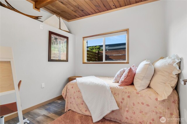 bedroom featuring baseboards, vaulted ceiling, wood ceiling, and wood finished floors
