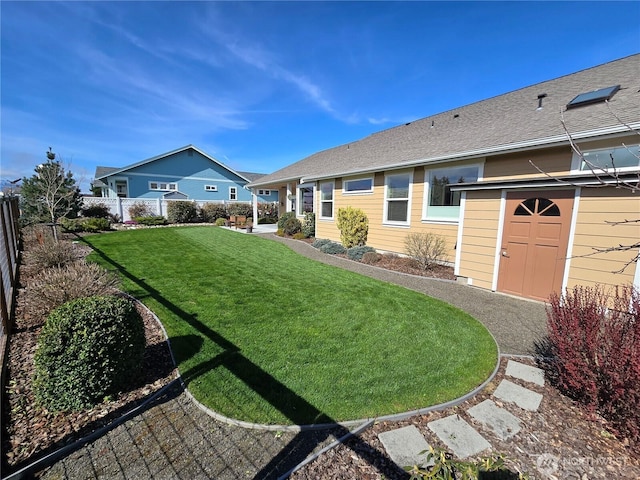 view of yard featuring a fenced backyard, an outdoor structure, and a storage unit