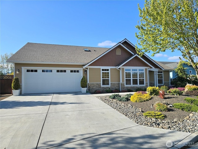 view of front of property with stone siding, a garage, and concrete driveway