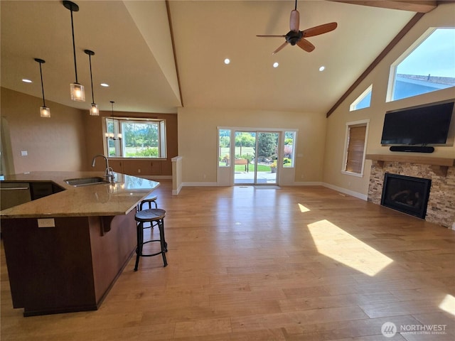 90 Broadmoor St, Sequim, WA 98382 - kitchen featuring a sink, open floor plan, high vaulted ceiling, baseboards, and a fireplace