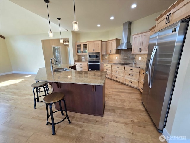 90 Broadmoor St, Sequim, WA 98382 - kitchen featuring stainless steel appliances, wall chimney range hood, a sink, light brown cabinetry, and baseboards
