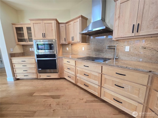 90 Broadmoor St, Sequim, WA 98382 - kitchen featuring stainless steel appliances, wall chimney range hood, light brown cabinetry, light wood finished floors, and light stone counters