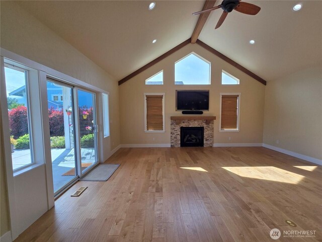 90 Broadmoor St, Sequim, WA 98382 - unfurnished living room featuring light wood-type flooring, ceiling fan, a stone fireplace, baseboards, and beam ceiling
