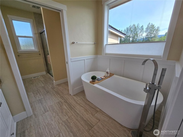 90 Broadmoor St, Sequim, WA 98382 - full bathroom with a stall shower, a soaking tub, a decorative wall, and wainscoting