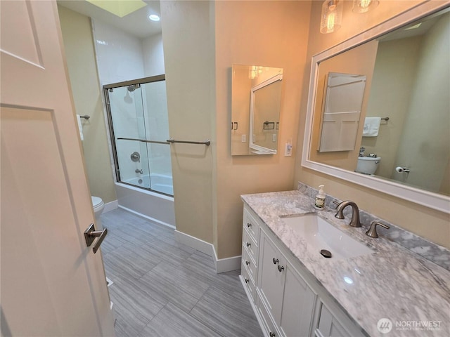 90 Broadmoor St, Sequim, WA 98382 - bathroom featuring toilet, baseboards, vanity, and bath / shower combo with glass door