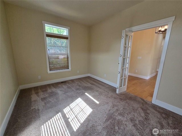 90 Broadmoor St, Sequim, WA 98382 - carpeted empty room with a chandelier, baseboards, and french doors