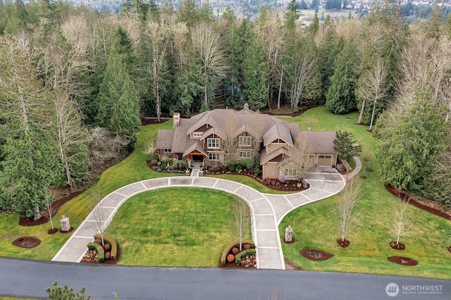 drone / aerial view featuring a forest view