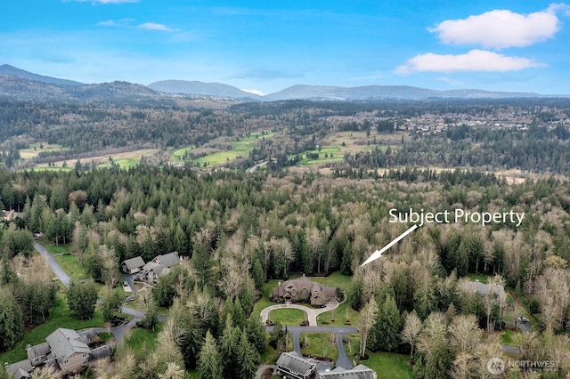 bird's eye view featuring a forest view and a mountain view
