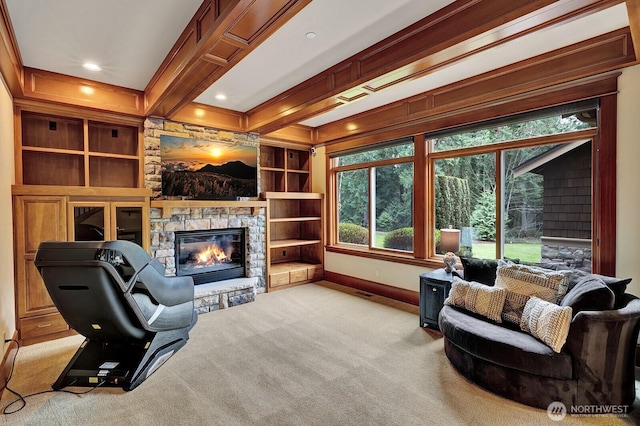 carpeted living room featuring baseboards, recessed lighting, beamed ceiling, crown molding, and a stone fireplace