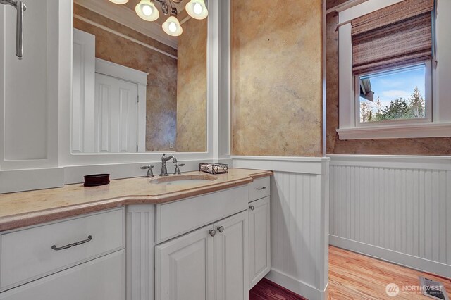 bathroom featuring wainscoting, vanity, wood finished floors, and visible vents