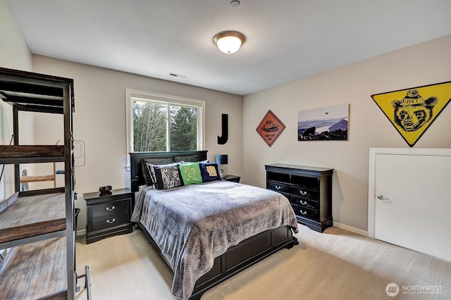 bedroom featuring baseboards and visible vents