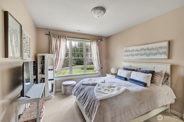 carpeted bedroom featuring baseboards and visible vents