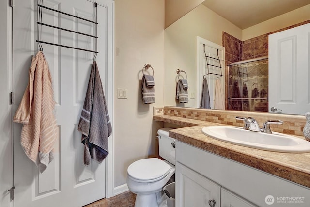 full bath featuring backsplash, toilet, vanity, and tiled shower