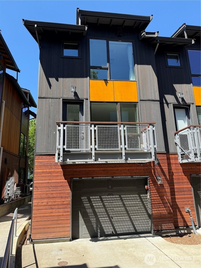 6528C 32nd Ave NE Unit 5.1, Seattle, WA 98115 - back of property featuring an attached garage and a balcony