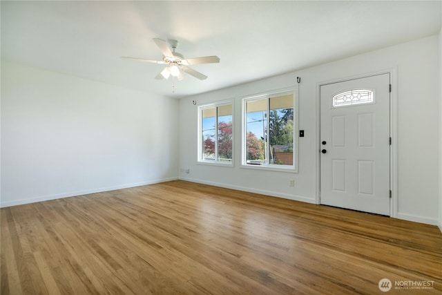entryway featuring light wood-style floors, a ceiling fan, and baseboards