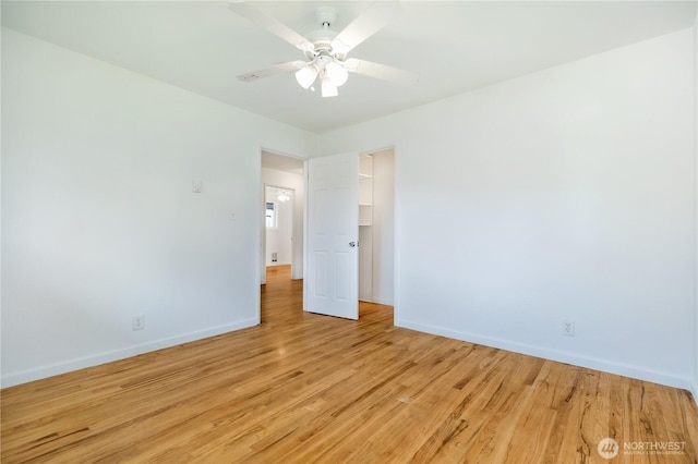 unfurnished room featuring a ceiling fan, baseboards, and light wood-style flooring