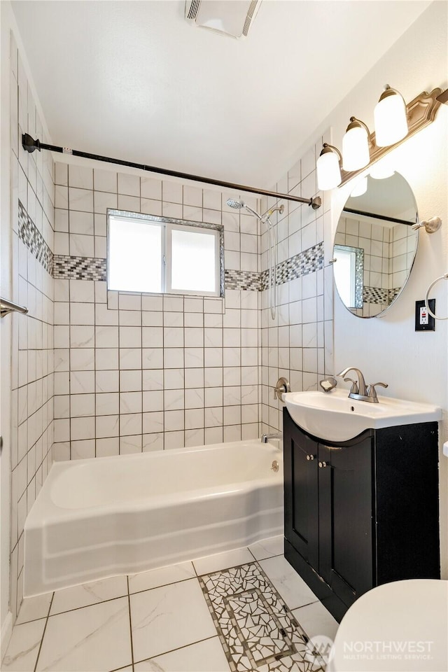 bathroom with toilet, visible vents, vanity, and shower / bath combination
