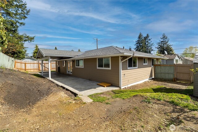 rear view of house featuring a patio area and a fenced backyard