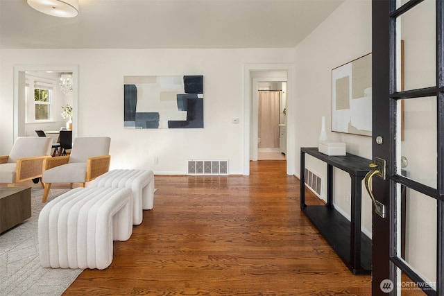interior space featuring visible vents, baseboards, and wood finished floors