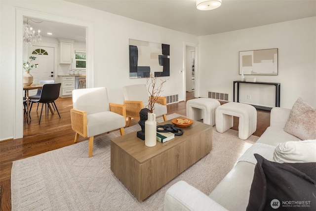 living area featuring visible vents and light wood finished floors