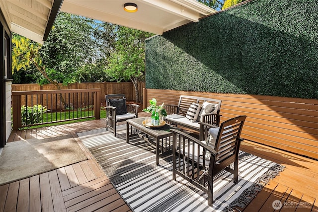 wooden deck featuring fence and outdoor lounge area