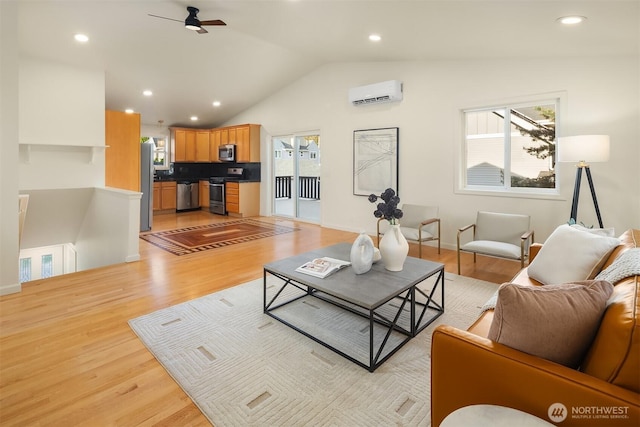 living area featuring a wall unit AC, a ceiling fan, lofted ceiling, and a wealth of natural light