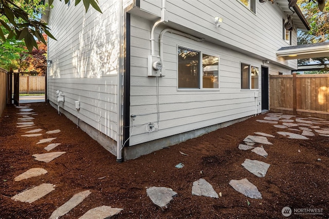 view of side of home with a fenced backyard