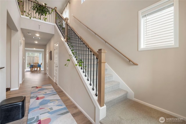 26334 203rd Pl SE, Covington, WA 98042 - stairs featuring wood finished floors and a towering ceiling