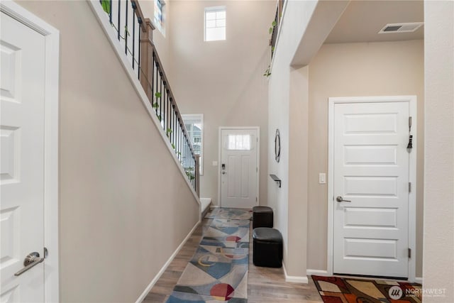 26334 203rd Pl SE, Covington, WA 98042 - foyer entrance featuring light wood finished floors, a high ceiling, and stairway