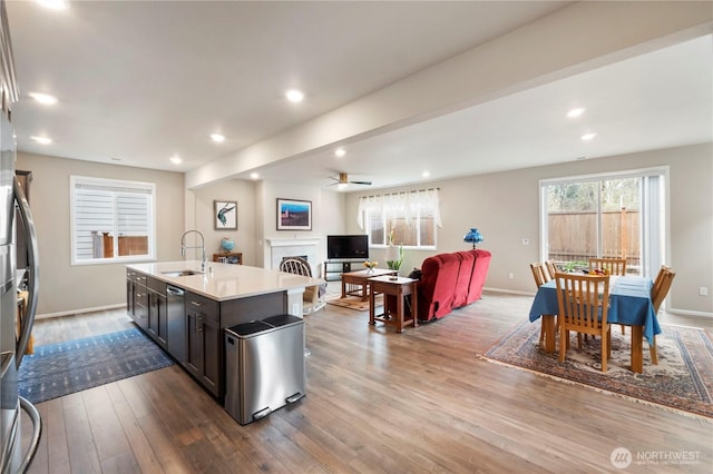 26334 203rd Pl SE, Covington, WA 98042 - kitchen featuring ceiling fan, a fireplace, light countertops, wood finished floors, and open floor plan