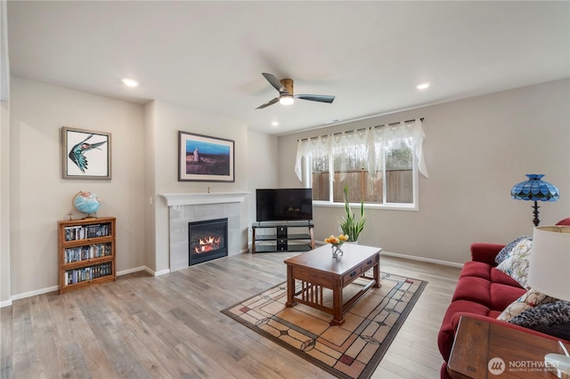 26334 203rd Pl SE, Covington, WA 98042 - living room with a ceiling fan, a fireplace, wood finished floors, and recessed lighting